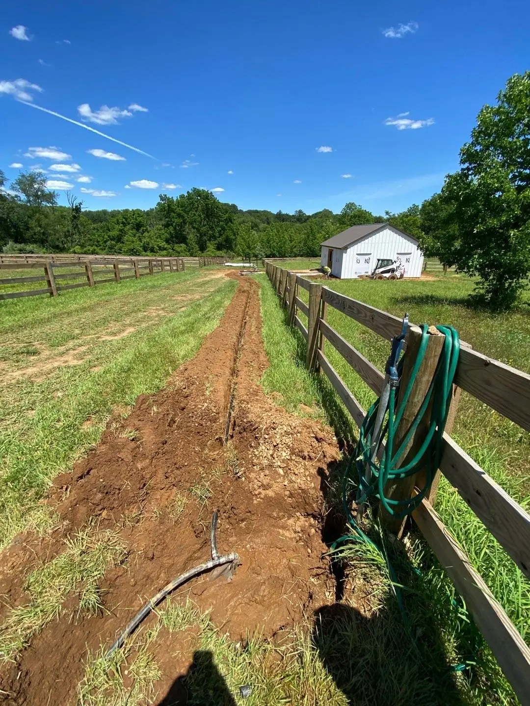 Drain-line trench running across a horse paddock toward the barn in West Chester, PA