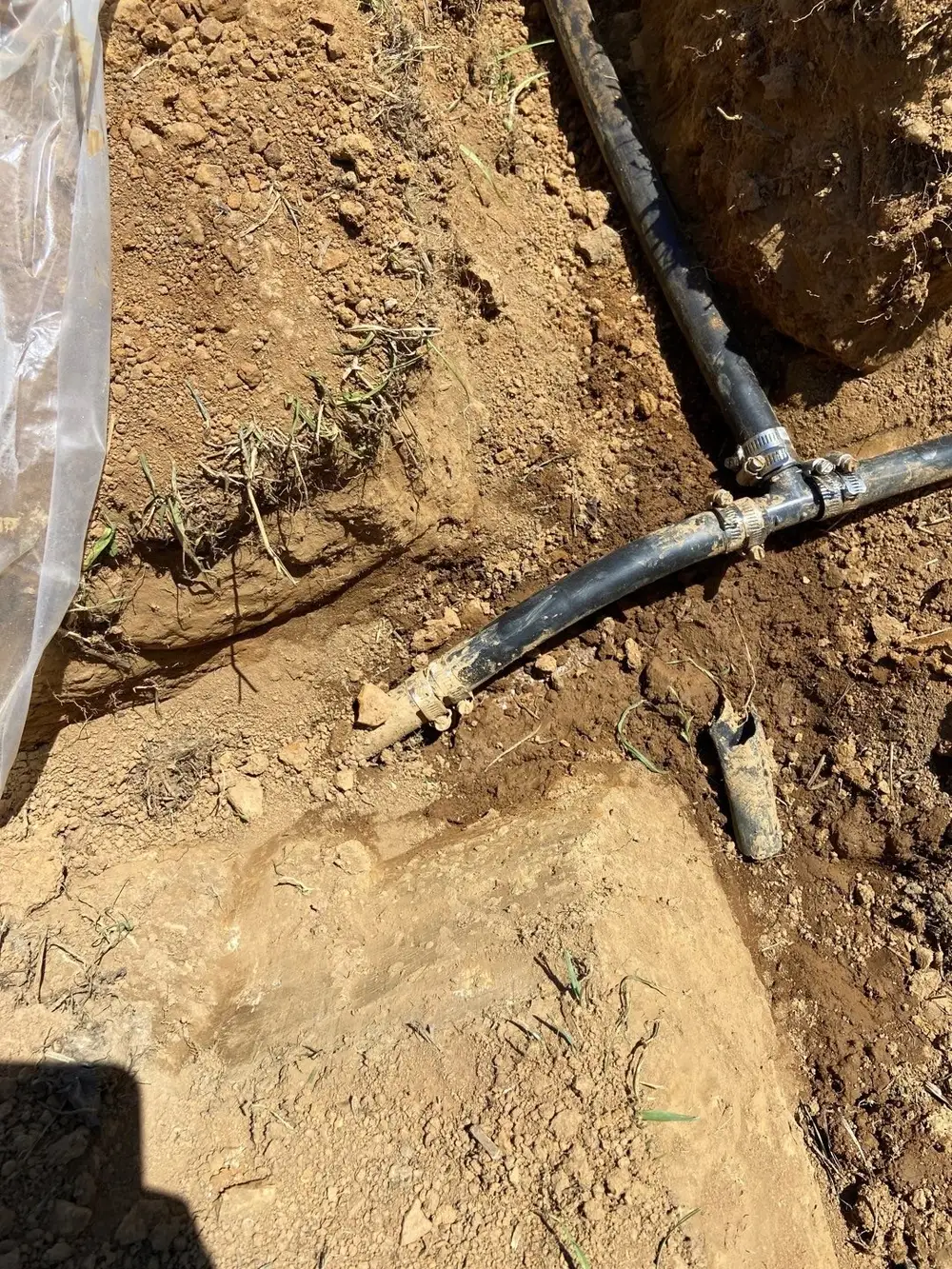 Black drainage pipe coupling connection in an open trench, West Chester, PA