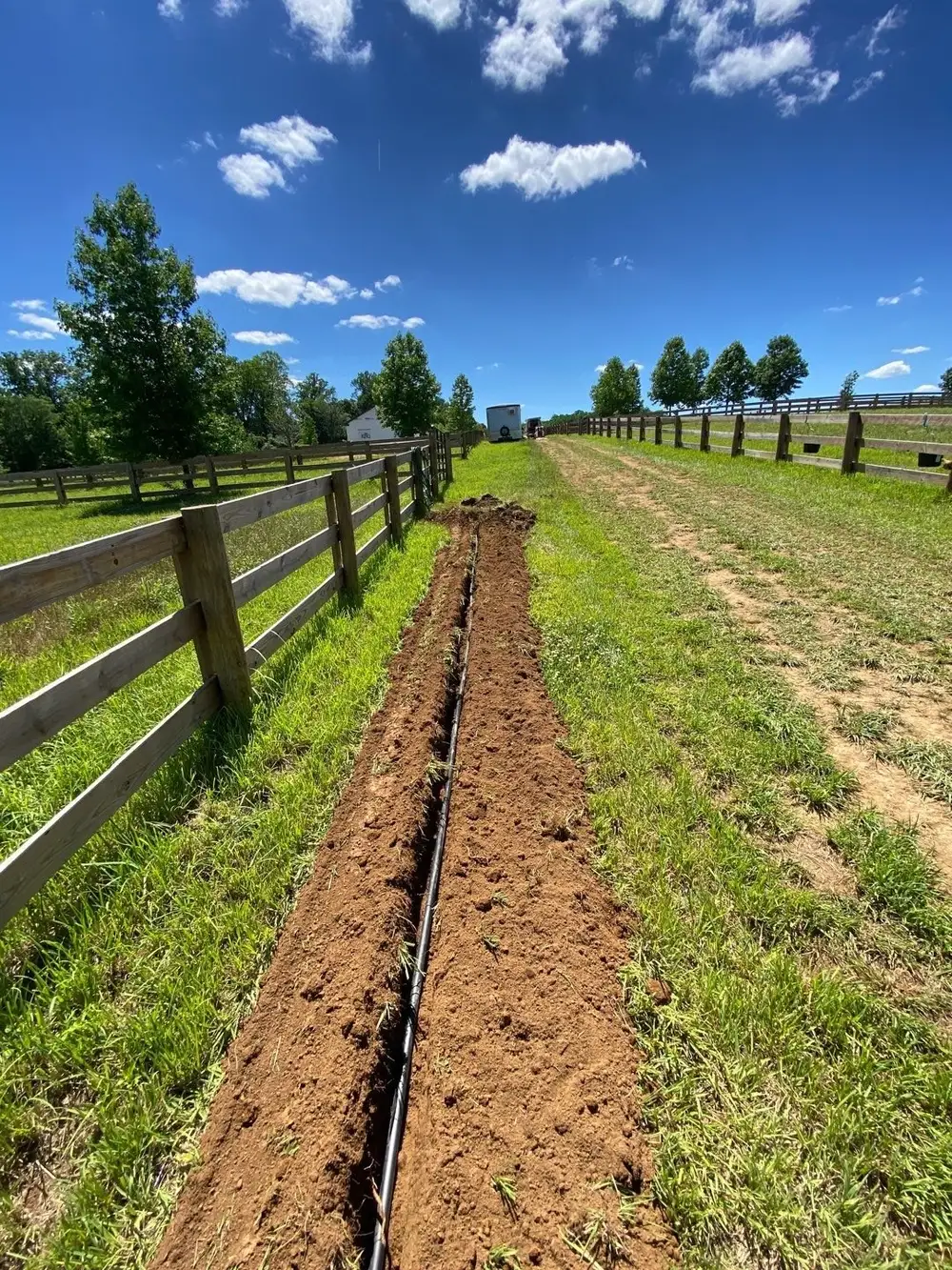 Open drainage trench along a paddock fence at a West Chester, PA horse farm