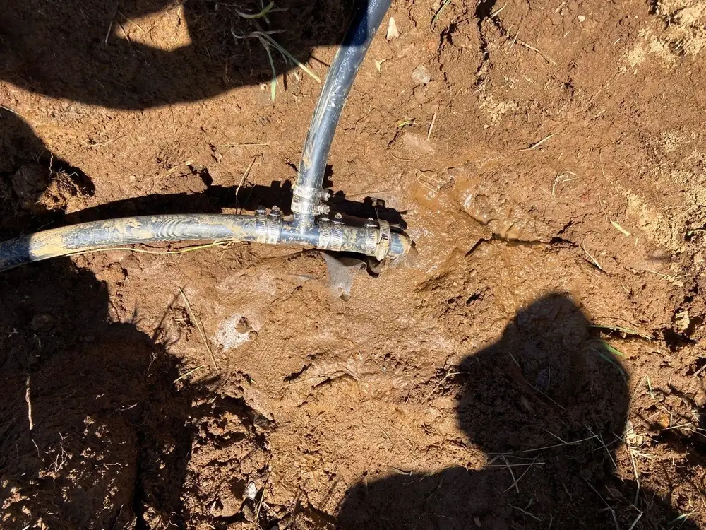French drain pipe coupling joined in the trench in Chester County clay soil